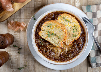 French onion soup with toasted cheese baguette garnished with thyme