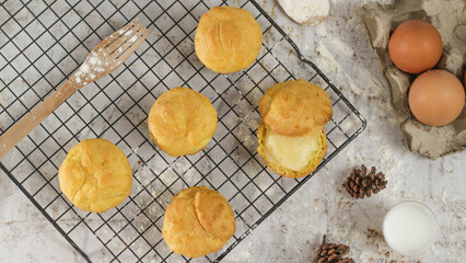 a traditional cake from Indonesia called kue sus filled with cream puffs. served on a cake rack. Food concept photo.