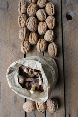 Mushrooms in a paper bag and nuts on a vintage table.