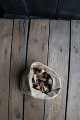 Mushrooms in a paper bag on a vintage table.