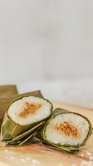 a close up of lontong. Traditional food from Indonesia originating from rice filled with vegetables or meat and wrapped in banana leaves. Indonesian traditional food photo concept.