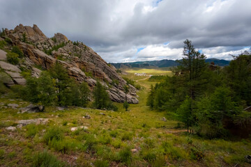 Terelj national park landscape, mountain ridge in Mongolia. Overview of the valley with the dramatic sky in the background.