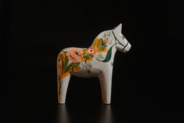 Black toy horse isolated on black background