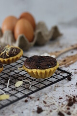 Small chocolate pie with almonds topping served on a cake rack, tastes sweet and savory. Food concept photo.