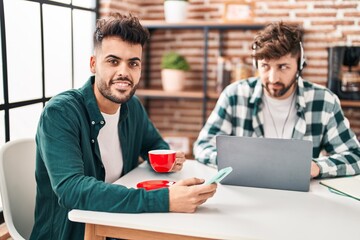 Young couple using laptop and smartphone teleworking at home
