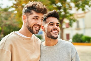 Young couple smiling confident hugging each other at park