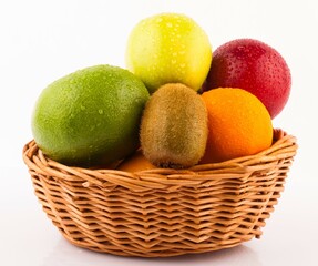 Mixed fruit in a wicker basket on a white backgrpound