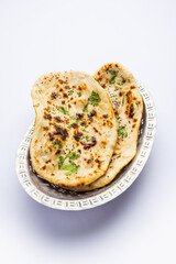 Tandoori naan, Indian Tandoori roti or flat bread served in a plate, isolated