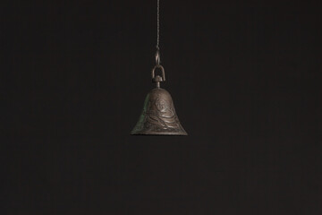 Solid brass or bronze vintage bell on black background