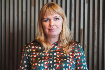 Defocus blonde young woman portrait indoor. Wooden lines on the background. Lifestyle women....