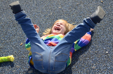 The little boy is naughty. The child lies on the ground and cries, yells. Bad behavior, childish...