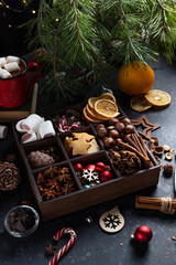 On the table there is a box with nine compartments in which nuts, cookies and spices are poured