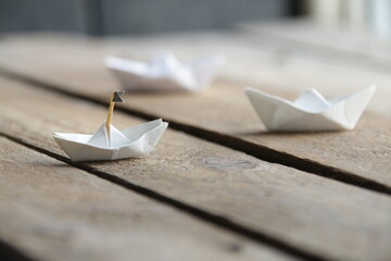 Beautiful paper boats on a vintage background.