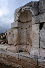 View from ruins of Sagalassos ancient city with monuments buildings and fountain with cloudy blue sky 