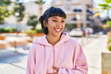 Young woman smiling confident standing at street