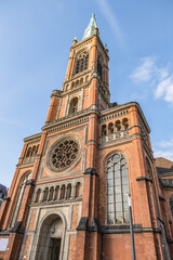 Fototapeta na wymiar Protestant St John's Church (Johanneskirche, 88 m high tower) in the square of Martin-Luther. Church of St John built from 1875 to 1881 in Romanesque Revival style. DUSSELDORF, GERMANY.