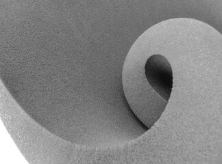 thick gray foam sheet rolled up in spiral style isolated on white background