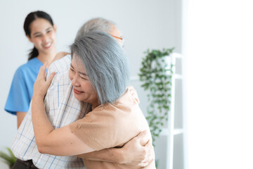 Portrait of happy senior couple with wife embracing husband, nurse doctor senior care caregiver help assistance retirement at home nursing, or hugging after sick in hospital