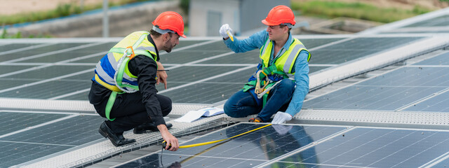 technician engineer team working to service and maintenance solar panel power system on rooftop,...
