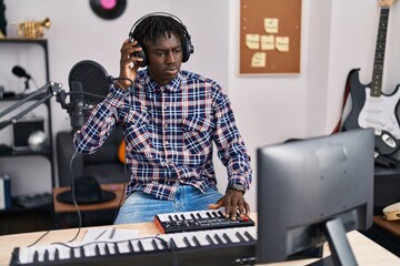 African american man musician having dj session at music studio
