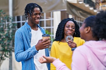 African american friends having breakfast standing together at street