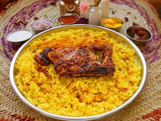 Mandi Chicken or biryani, majboos, kabsa and machboos served in dish isolated on table top view of arab food
