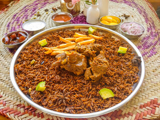 Machboos lamb or biryani, mandi, kabsah and raita served in dish isolated on table top view of arab food