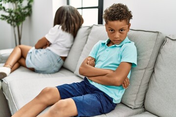 Brother and sister angry having problem sitting on sofa at home