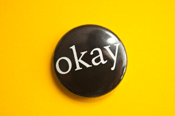 black button with Okay word on it