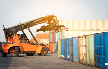 A container forklift is working in the container yard.