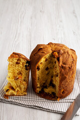 Homemade Italian Panettone with Raisins and Large Pieces of Candied Fruit, side view. Copy space.