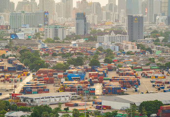 Aerial view of container cargo ship in the export and import business and logistics international goods in urban city. Shipping to the harbour by crane in Bangkok harbour, Thailand.