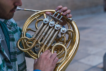 Man playing the horn in the street