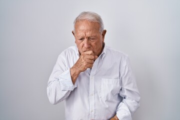 Senior man with grey hair standing over isolated background feeling unwell and coughing as symptom for cold or bronchitis. health care concept.