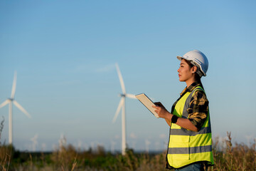 person with turbine in the field.worker in field. silhouette of female with a windmill. silhouette...