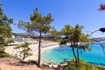 Fototapeta na wymiar Panoramic viewpoint of summer natural landscape, the seascape turquoise color, and the beautiful and clean Aegean sea. Pine trees surround coast. Holiday travel concept. 