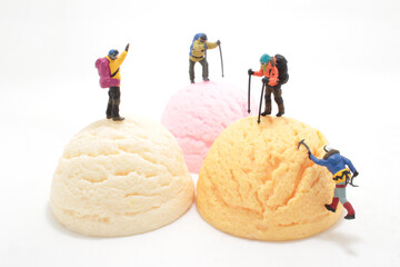 a mini of figurines climbing ice cream ball