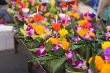 Loy Krathong in Thailand , floating on water in local street market festival. Celebration and Culture. People holiday at night. Thai event. it made by banana leaf.
