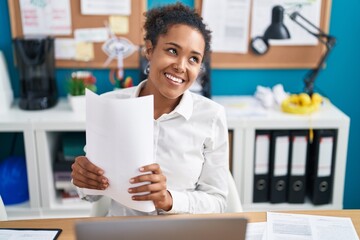 African american woman business worker holding documents at office
