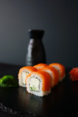 sushi on a black plate