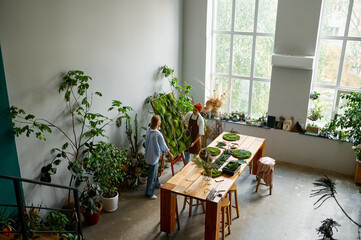 Floral design studio view with florists making decorations view from afar