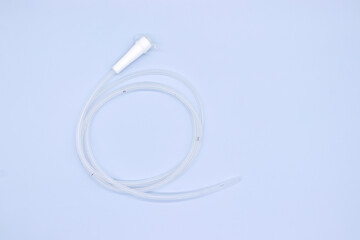 Nasogastric tube with white head on blue background,top view