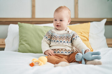 Fototapeta premium Adorable caucasian baby smiling confident sitting on bed at bedroom