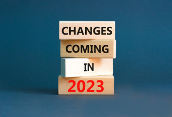 Changes coming in 2023 symbol. Concept word Changes coming in 2023 on wooden blocks. Beautiful grey table grey background. Business and changes coming in 2023 concept. Copy space.