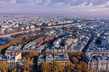 Beautiful panoramic view above historical Parisian buildings from the Eiffel Tower. Scenery of Paris and Seine River. Aerial view of roofs.