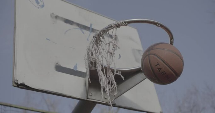 Scoring at basketball on an old vintage hoop in slow motion 4K F-LOG2 video format