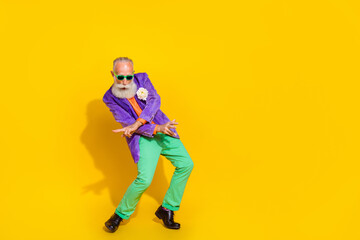 Fototapeta na wymiar Full length photo of positive charming guy dressed violet velvet jacket dancing disco empty space isolated yellow color background
