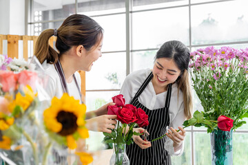 group of female florists Asians are arranging flowers for customers who come to order them for various ceremonies such as weddings, Valentine's Day or to give to loved ones.