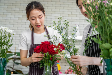group of female florists Asians are arranging flowers for customers who come to order them for...