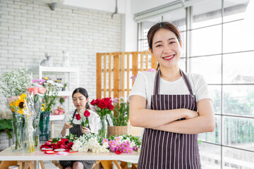 group of female florists Asians are arranging flowers for customers who come to order them for various ceremonies such as weddings, Valentine's Day or to give to loved ones.
